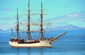 white and brown ship on sea under blue sky during daytime