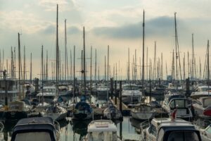 white and blue boats on dock during daytime