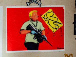 man in blue shirt holding rifle painting